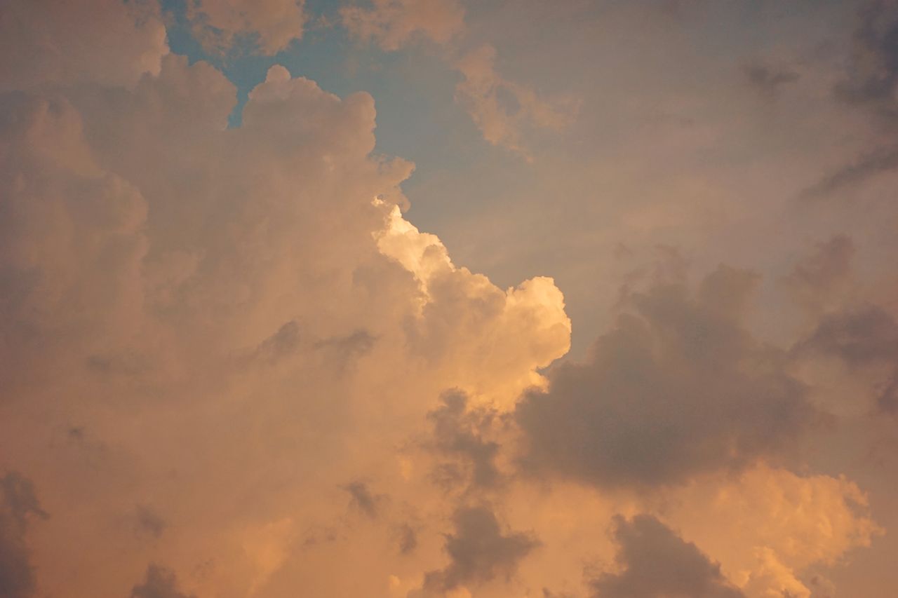 stunning golden hour sky filled with fluffy layered clouds in a captiv