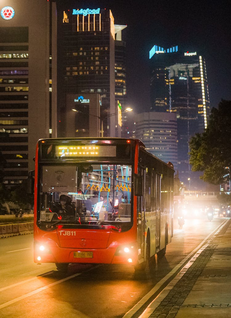 Red Bus On City Road During Night Time