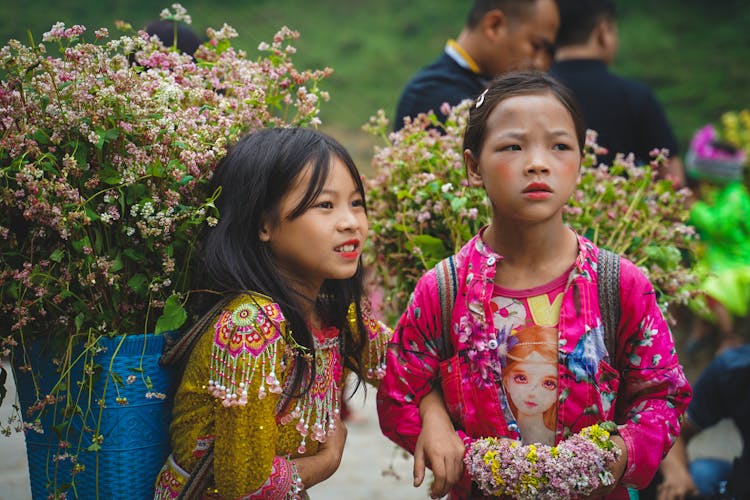 Girls Carrying Flowers