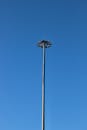 Lamp on a High Pole in Front of Blue Sky
