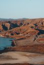 View of Coastline and Road Meandering at Feet of Mountains