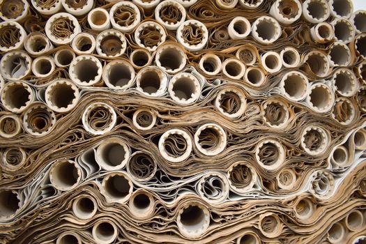Close-up view of rolled papers creating a complex industrial pattern.