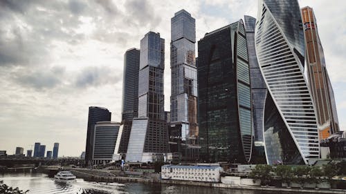 High Rise Building Near a River Under Cloudy Sky