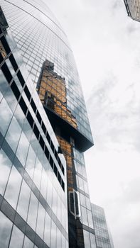 Reflections on a modern glass skyscraper in Moscow, Russia.