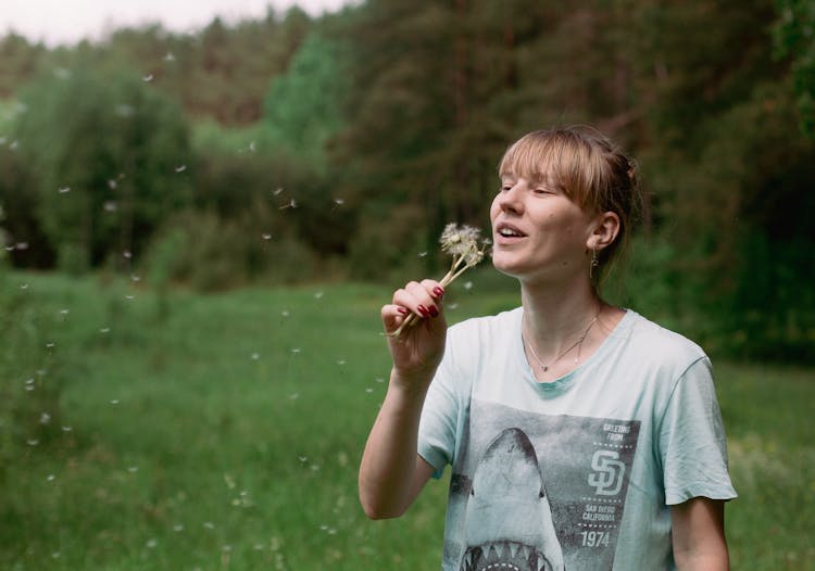 Woman Blowing Dandelions