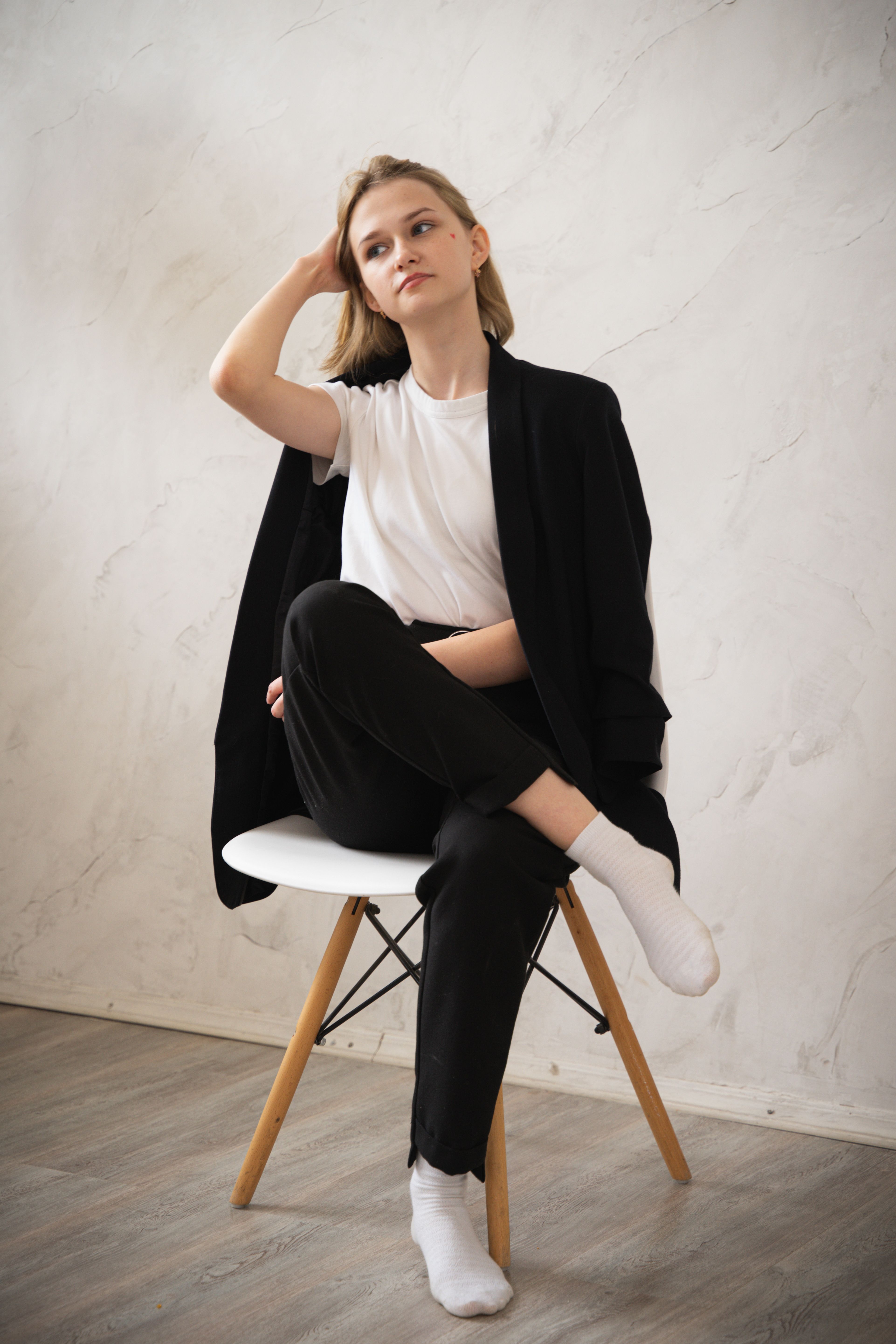 Woman in White Shirt and Black Blazer Sitting on a Chair · Free Stock Photo