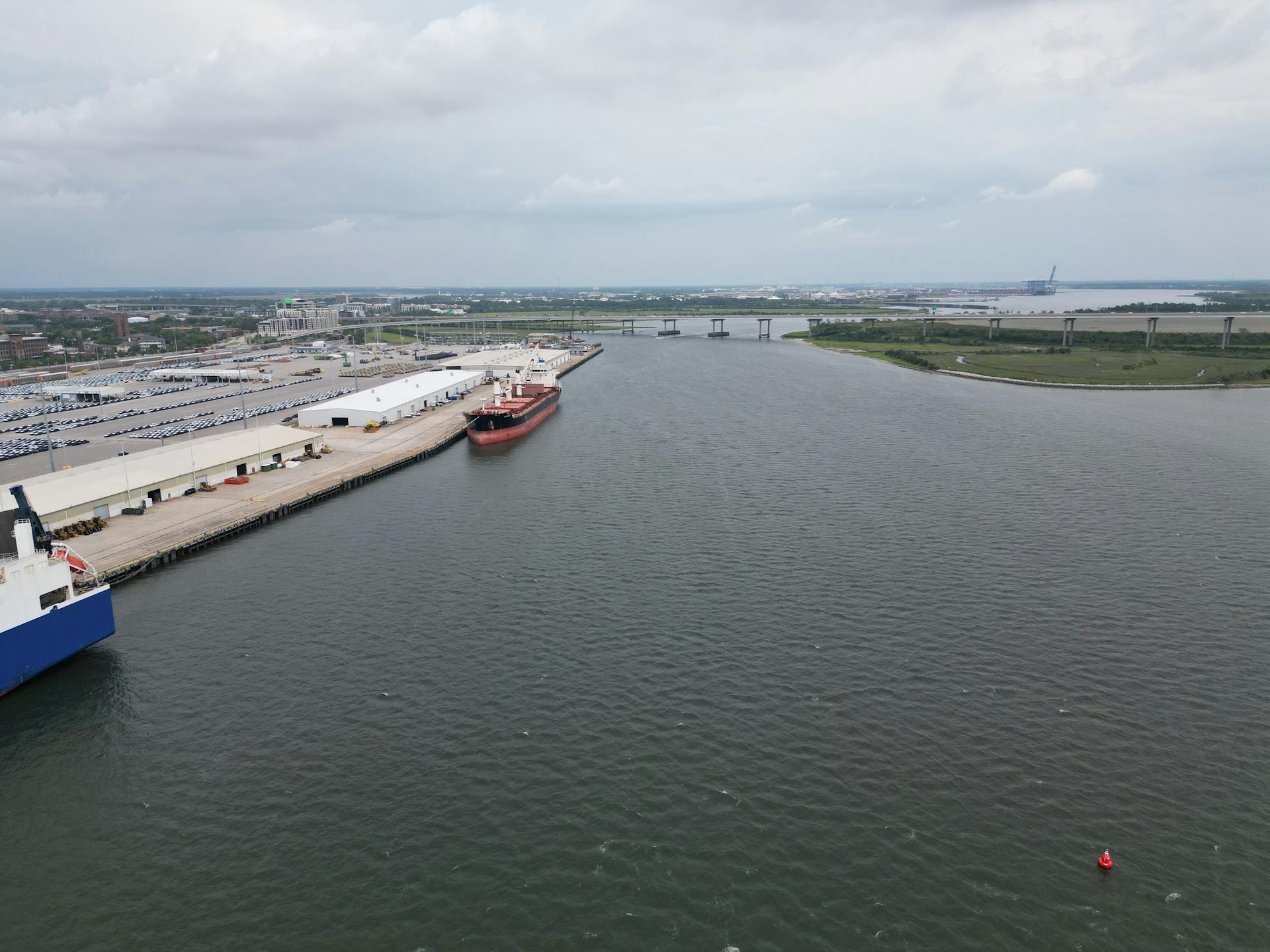 Aerial photo showcasing the busy port of Charleston, SC with cargo ships and docks.