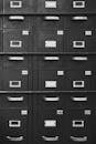 Grayscale Photography of Wooden Cabinets with Drawers