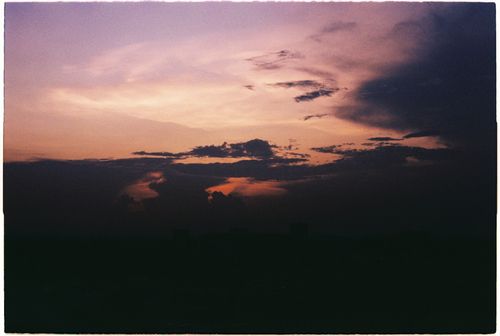 Free A striking dusk sky with warm and cool tones showcasing vibrant clouds at sunset. Stock Photo