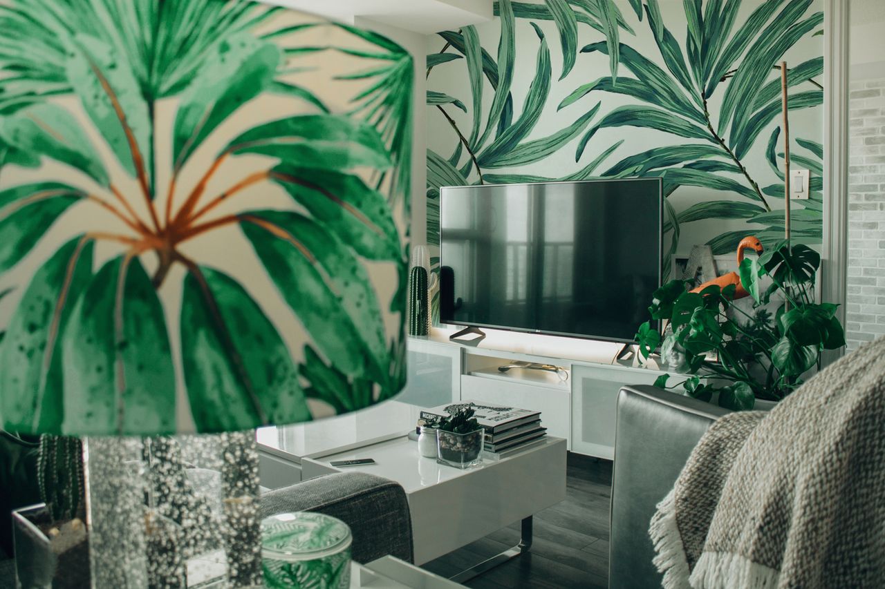 a cozy modern living room features tropical decor and indoor plants