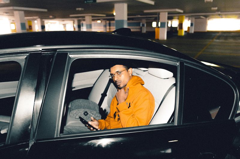 Person checking a phone in a parked car