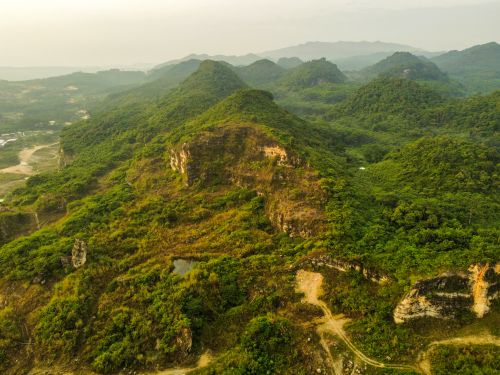 Free Stunning aerial view of lush green hills and valleys, showcasing natural beauty and geological formations. Stock Photo