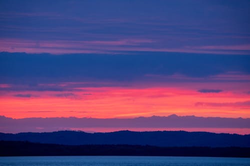 Dramatic Pink Sky above Water on Sunset