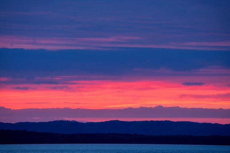 Dramatic Pink Sky Above Water On Sunset