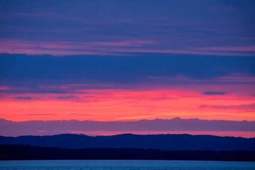 Free Breathtaking sunset with vivid pink and blue hues over water at Maple Springs, Minnesota. Stock Photo