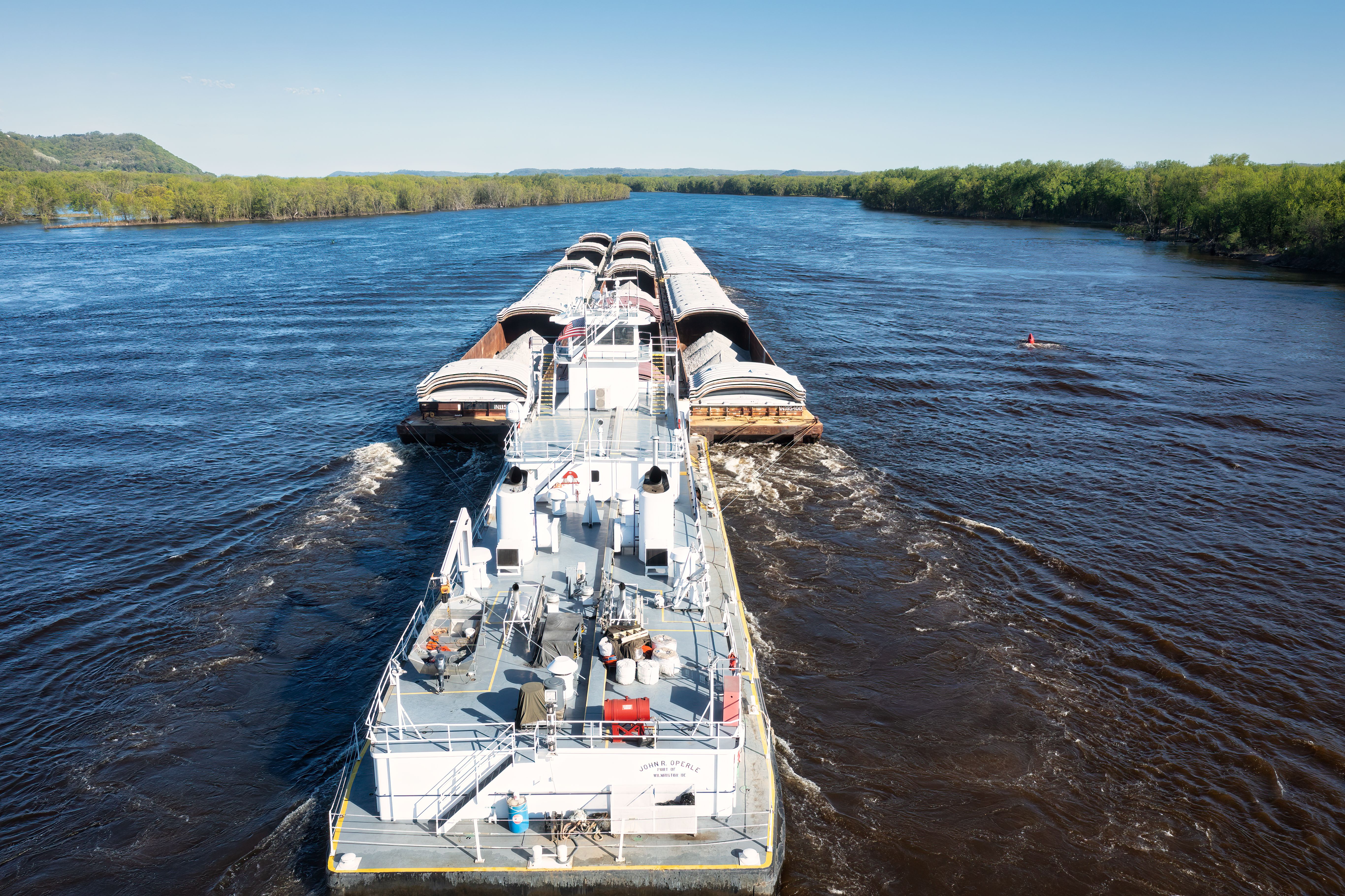 Aerial view of a cargo barge navigating the scenic Mississippi River near Wabasha, MN.