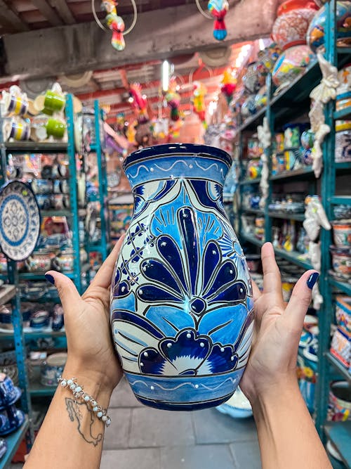 Hands Holding Blue Ceramic Vase
