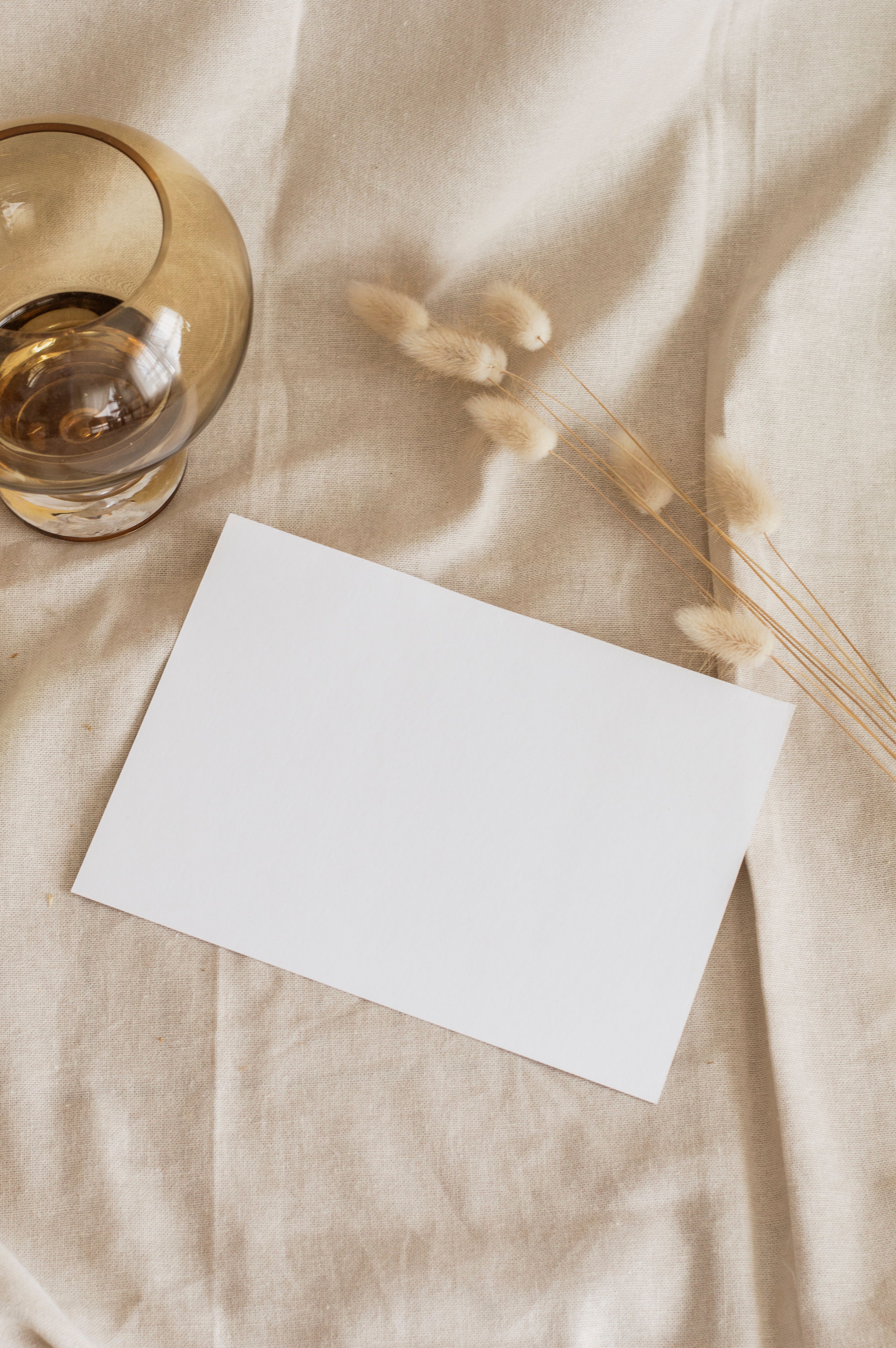 A Blank Paper and Dried Flowers on a Fabric · Free Stock Photo