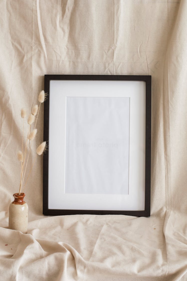 An Empty Frame On A Beige Fabric