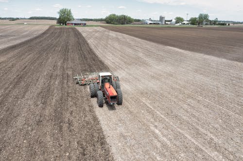 Aerial Photography of Tractor Plowing the Field