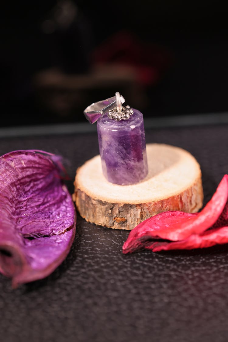 Purple Candle Over A Piece Of Wood