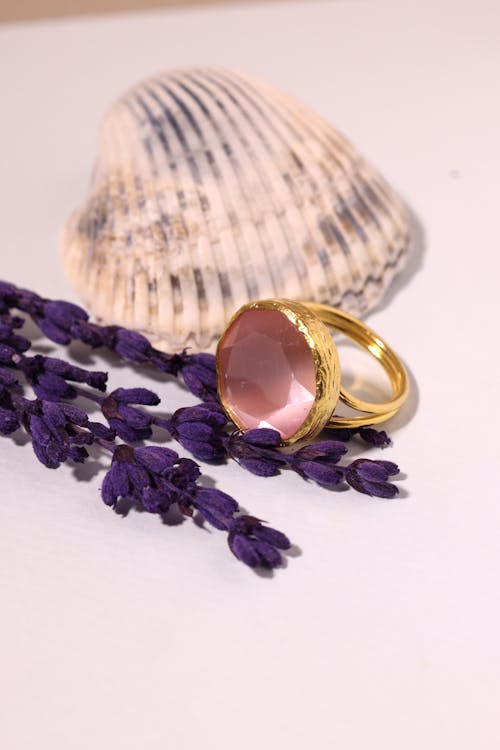 Photo of a Composite of Lavender, a Seashell and a Golden Ring with a Pink Crystal