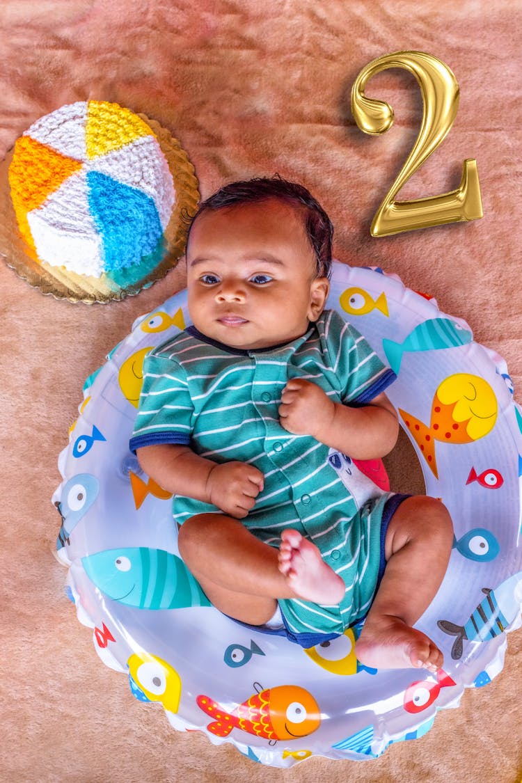 A Baby Lying On Inflatable Ring 