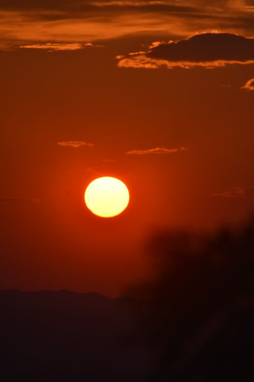 Free Capture of a vibrant sunset with a red sky and glowing sun over Tirana, Albania. Stock Photo