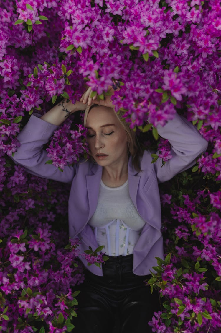 Blonde Woman Embraced By Purple Rhododendron Blossom