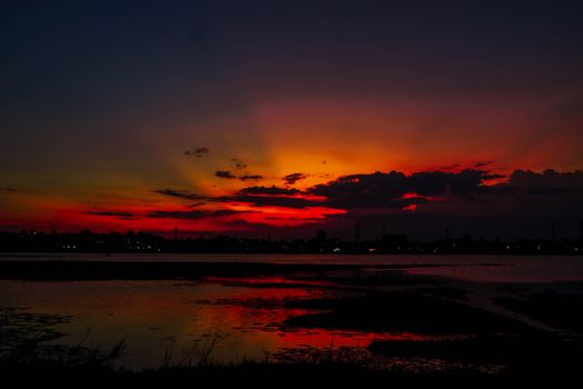 A breathtaking view of vibrant sunset colors casting reflections on a calm lake.