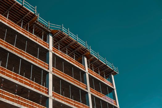 Modern building framework under construction against a clear sky in Minneapolis.