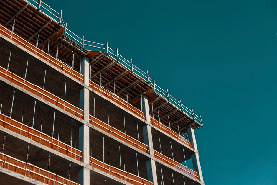Modern building framework under construction against a clear sky in Minneapolis.