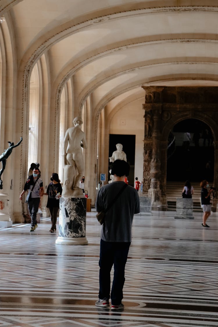 Busy People Walking On The Hallway Of A Building