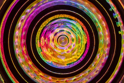 Colorful, abstract circular kaleidoscope pattern with vibrant hues for creative backgrounds.