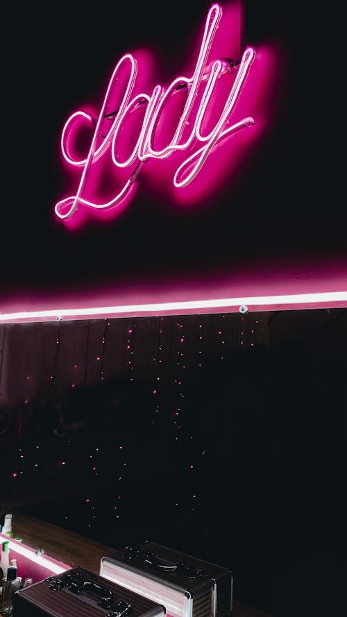 Pink Neon Sign on Black Wall