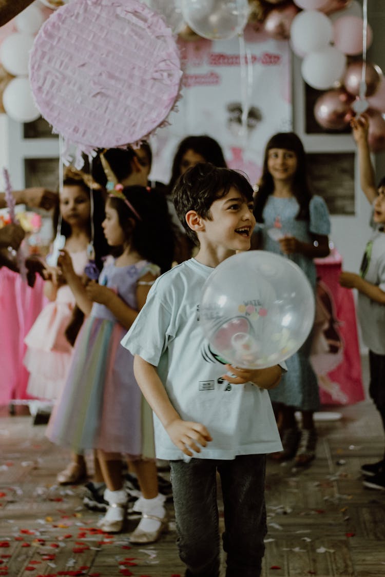 Young Boy Holding A Balloon