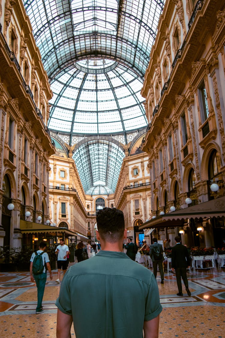 Man Standing In Old Historic Shopping Gallery