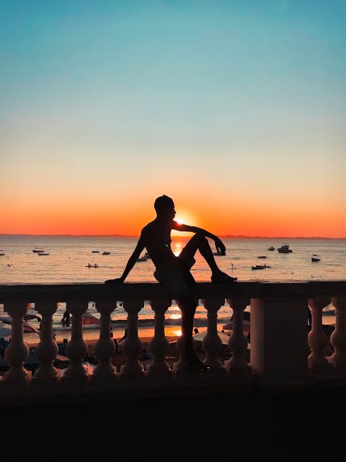 Silhouette of a Person on the Beach during Sunset