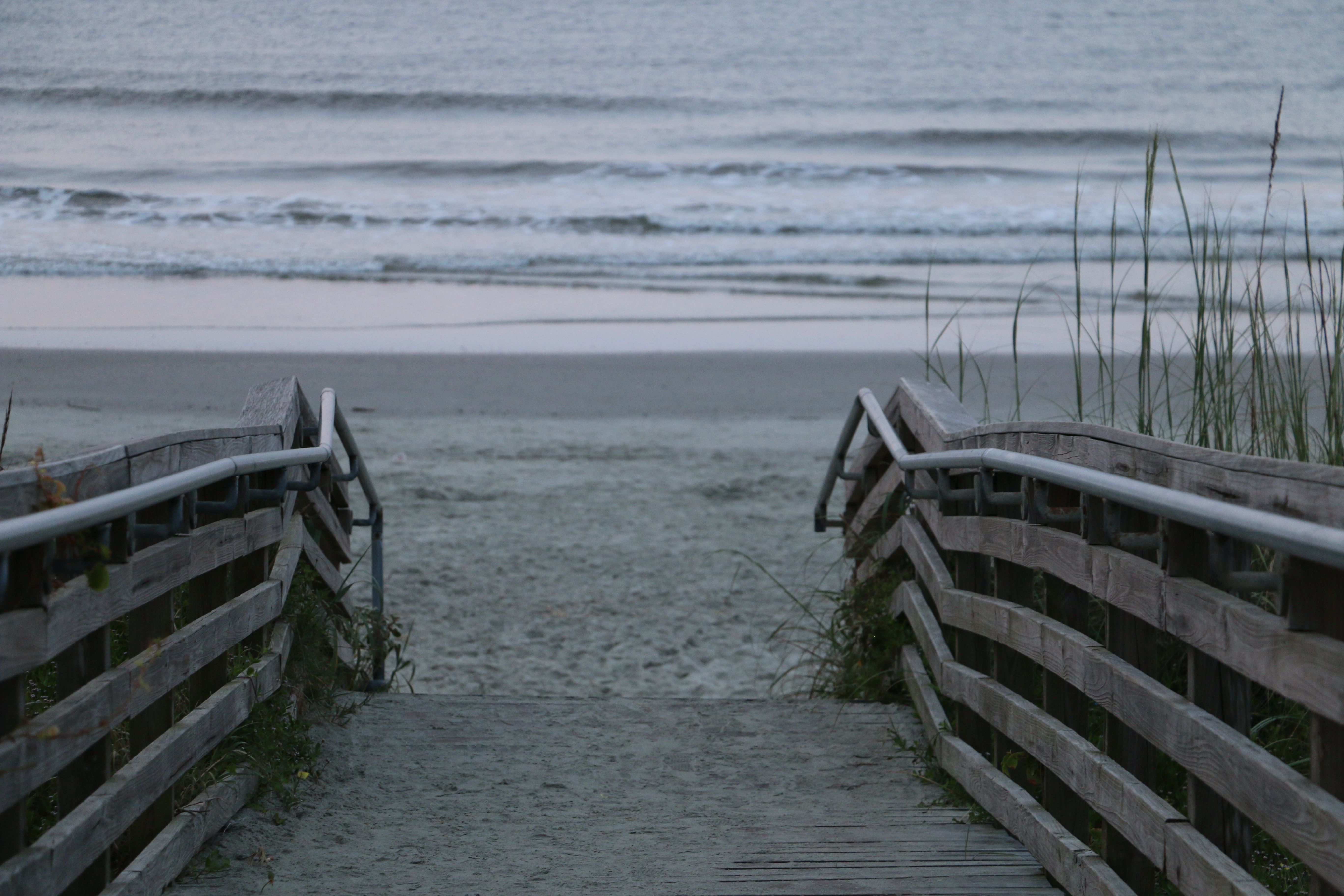 Wooden beach access boardwalk leading to white sand on the Emerald Coast near Scenic Highway 30A
