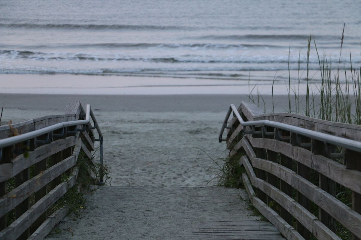 Wooden walkway leading to a peaceful Atlantic beach