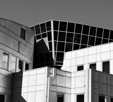 Dynamic modern architecture with geometric shapes and bold lines in a stark black and white composition.