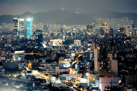 Stunning Mexico City skyscrapers illuminated at nightfall with an urban landscape backdrop.