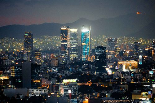 Free Captivating cityscape of Mexico City skyline at dusk with illuminated skyscrapers. Stock Photo