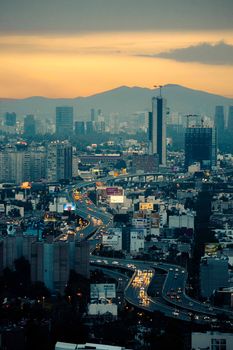 A breathtaking aerial view of Mexico City's skyline illuminated at dusk, showcasing urban vibrancy.