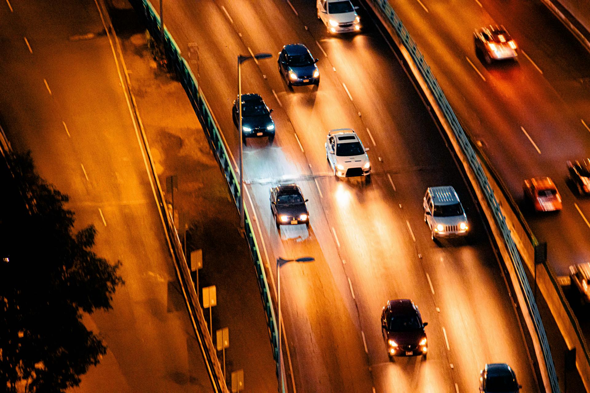 Aerial view of nighttime traffic on a bustling highway in Mexico City.