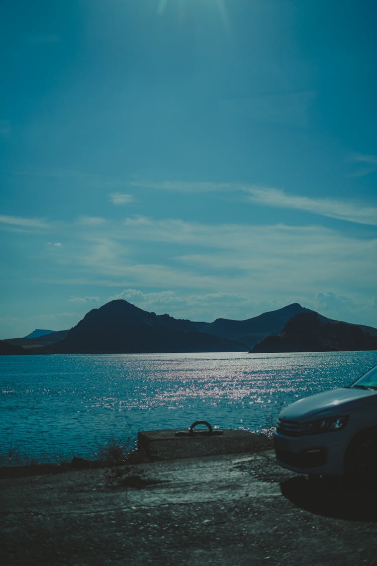 Car On Pier Near Blue Sea On Dawn