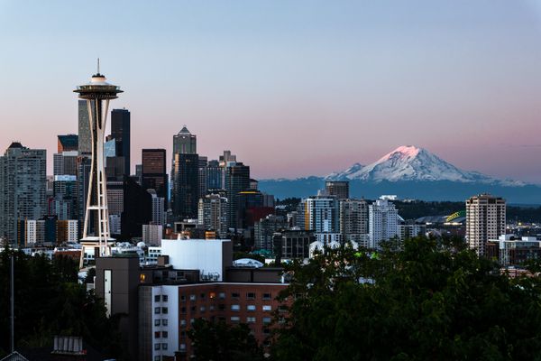 Seattle skyline with the Space Needle and Mount Rainier at dawn, the view that greets people moving to Washington State