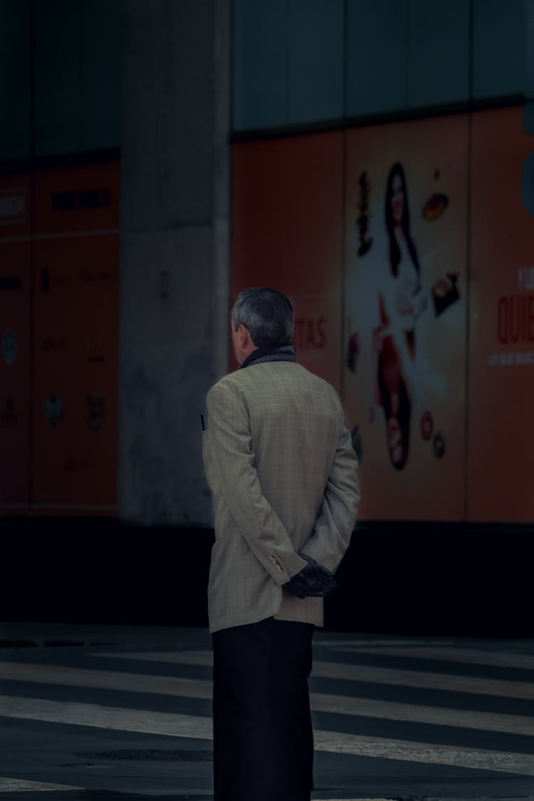 Man In Beige Suit Standing On The Pedestrian Lane