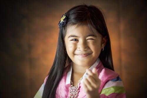 Free Girl Smiling Doing Finger Heart Sign Stock Photo