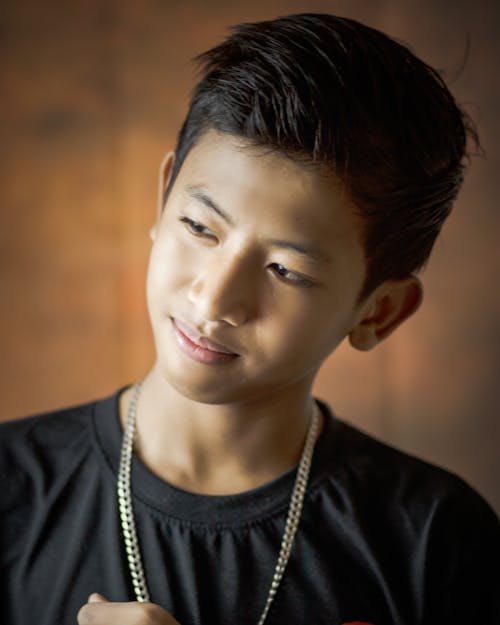 Close-Up Photography of Boy Wearing Necklace